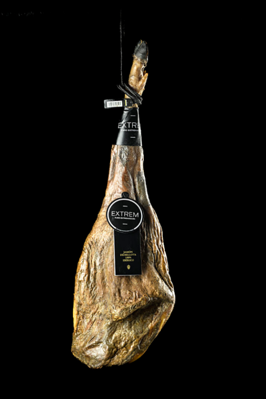 Ham leg with 'EXTREM' branding on a black background