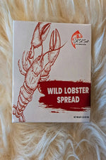 Box of wild lobster spread with a lobster illustration on a fluffy white surface