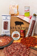 Tapas Box with Señorío de Montanera salchichón vela, standard Redondo Iglesias chorizo, La Curiosa mussels, Perelló olives, Serrano ham, sliced charcuterie and Picos Camperos.